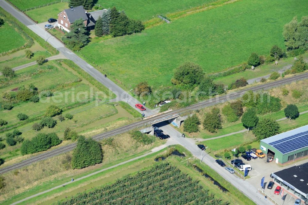 Hamburg from the bird's eye view: Railway viaduct over the Koeterdamm road in Hamburg-Finkenwerder. A project of the Hamburg Port Authority HPA