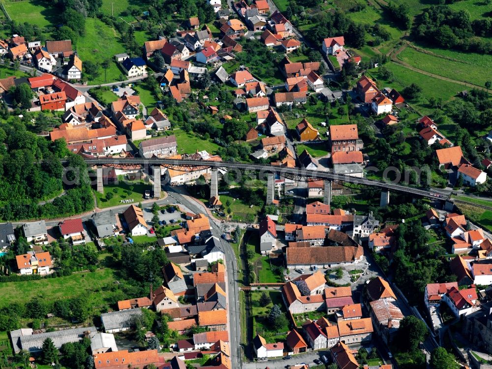 Aerial image Lengenfeld unterm Stein - Railroad viaduct in Lengenfeld unterm Stein in the state of Thuringia. The viaduct crosses the village with a length of 237m and is 24m high. The bridge has not been used since 1992 but is a listed memorial of traffic history