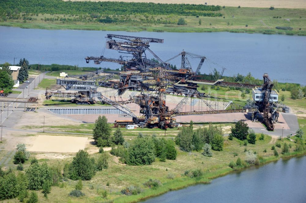 Aerial image Gräfenhainichen - Die Eisenstadt Ferropolis entstand aus den Überresten des Braunkohle Tagebaus Golpa-Nord. Der Tagebau wurde geflutet. Einige Braunkohlebagger erinnern an den Tagebau. Heute finden in Ferropolis Festivals, Konzerte und an dere Veranstaltungen statt.Außerdem beherbergt die Halbinsel ein Museum. Ferropolis, called City of Metal. It is situated on the area of the former opencast mining Golpa-Nord. The opencast mining got flooded. Some of the huge excavators are situatet on the area. Today festivals, concerts and other events take place there. There also is a museum.