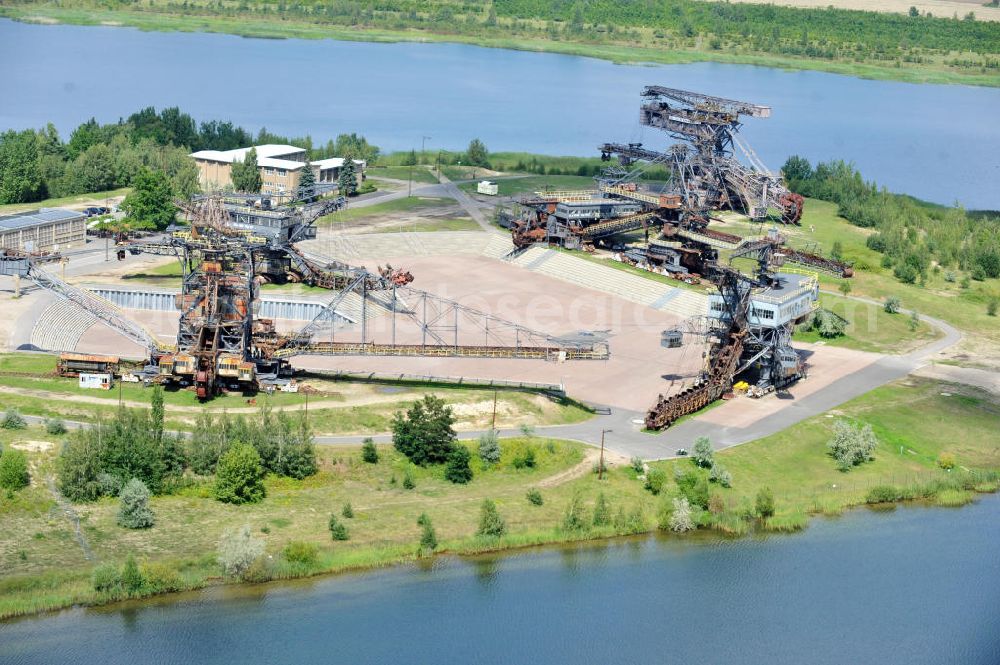 Aerial image Gräfenhainichen - Die Eisenstadt Ferropolis entstand aus den Überresten des Braunkohle Tagebaus Golpa-Nord. Der Tagebau wurde geflutet. Einige Braunkohlebagger erinnern an den Tagebau. Heute finden in Ferropolis Festivals, Konzerte und an dere Veranstaltungen statt.Außerdem beherbergt die Halbinsel ein Museum. Ferropolis, called City of Metal. It is situated on the area of the former opencast mining Golpa-Nord. The opencast mining got flooded. Some of the huge excavators are situatet on the area. Today festivals, concerts and other events take place there. There also is a museum.