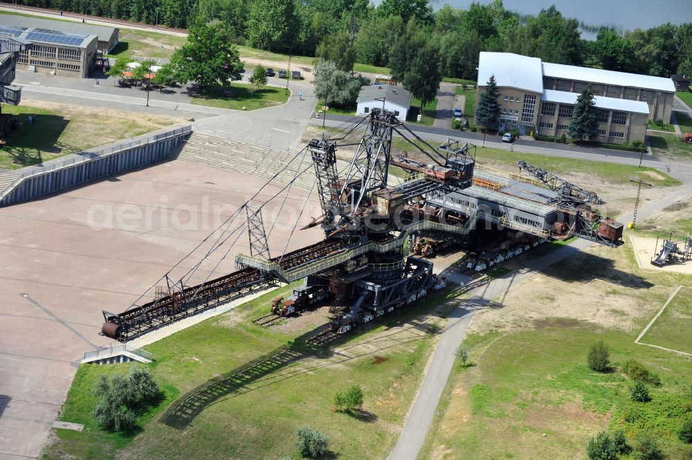 Gräfenhainichen from the bird's eye view: Die Eisenstadt Ferropolis entstand aus den Überresten des Braunkohle Tagebaus Golpa-Nord. Der Tagebau wurde geflutet. Einige Braunkohlebagger erinnern an den Tagebau. Heute finden in Ferropolis Festivals, Konzerte und an dere Veranstaltungen statt.Außerdem beherbergt die Halbinsel ein Museum. Ferropolis, called City of Metal. It is situated on the area of the former opencast mining Golpa-Nord. The opencast mining got flooded. Some of the huge excavators are situatet on the area. Today festivals, concerts and other events take place there. There also is a museum.