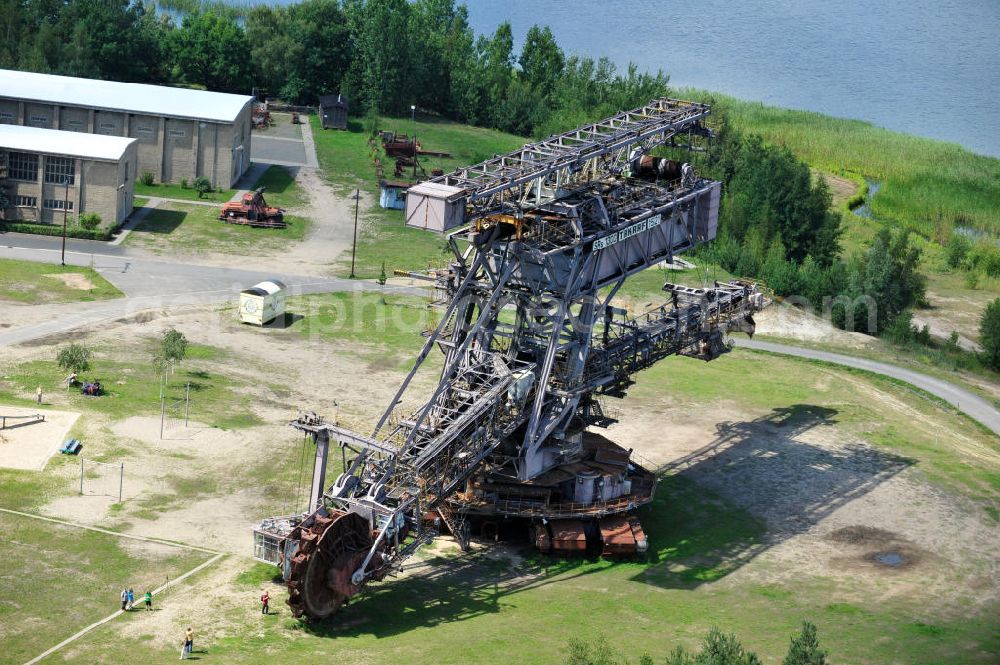 Aerial image Gräfenhainichen - Die Eisenstadt Ferropolis entstand aus den Überresten des Braunkohle Tagebaus Golpa-Nord. Der Tagebau wurde geflutet. Einige Braunkohlebagger erinnern an den Tagebau. Heute finden in Ferropolis Festivals, Konzerte und an dere Veranstaltungen statt.Außerdem beherbergt die Halbinsel ein Museum. Ferropolis, called City of Metal. It is situated on the area of the former opencast mining Golpa-Nord. The opencast mining got flooded. Some of the huge excavators are situatet on the area. Today festivals, concerts and other events take place there. There also is a museum.