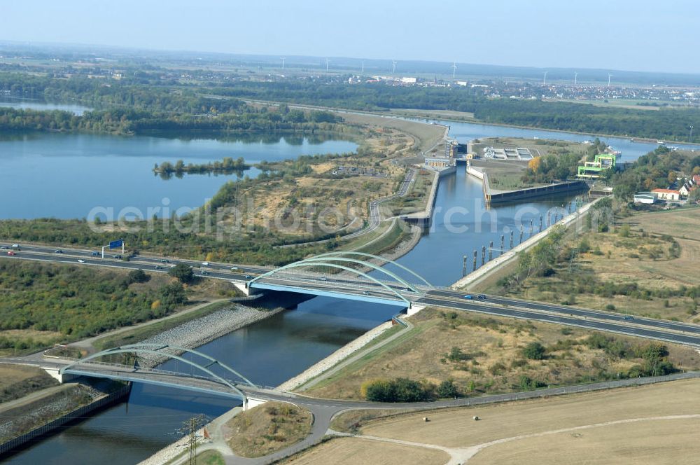 MAGDEBURG from the bird's eye view: Blick auf die Industriegebiete am Ufer des Elbe-Abstiegskanal, der den Magdeburger Binnen- Hafen mit der Schleuse Rothensee und dem Mittellandkanal verbindet: Dieser wird auf breiter Front derzeit ausgebaut. Die Bauvorhaben unterstützen die Bestrebungen der Magdeburger Hafengesellschaft, den größten Binnenhafen Mitteldeutschlands zu einer Drehscheibe des internationalen Schiffstransports zu machen. Kontakt WSV: Wasserstraßen-Neubauamt Magdeburg, 39106 Magdeburg, Tel. +49(0)391 535-0, email: wna-magdeburg@wsv.bund.de