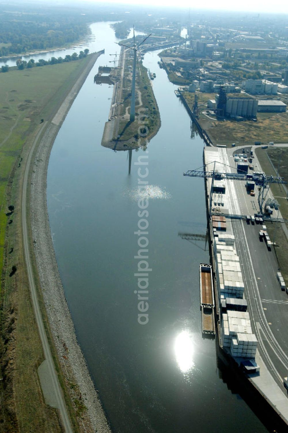 MAGDEBURG from the bird's eye view: Blick auf die Industriegebiete am Ufer des Elbe-Abstiegskanal, der den Magdeburger Binnen- Hafen mit der Schleuse Rothensee und dem Mittellandkanal verbindet: Dieser wird auf breiter Front derzeit ausgebaut. Die Bauvorhaben unterstützen die Bestrebungen der Magdeburger Hafengesellschaft, den größten Binnenhafen Mitteldeutschlands zu einer Drehscheibe des internationalen Schiffstransports zu machen. Kontakt WSV: Wasserstraßen-Neubauamt Magdeburg, 39106 Magdeburg, Tel. +49(0)391 535-0, email: wna-magdeburg@wsv.bund.de