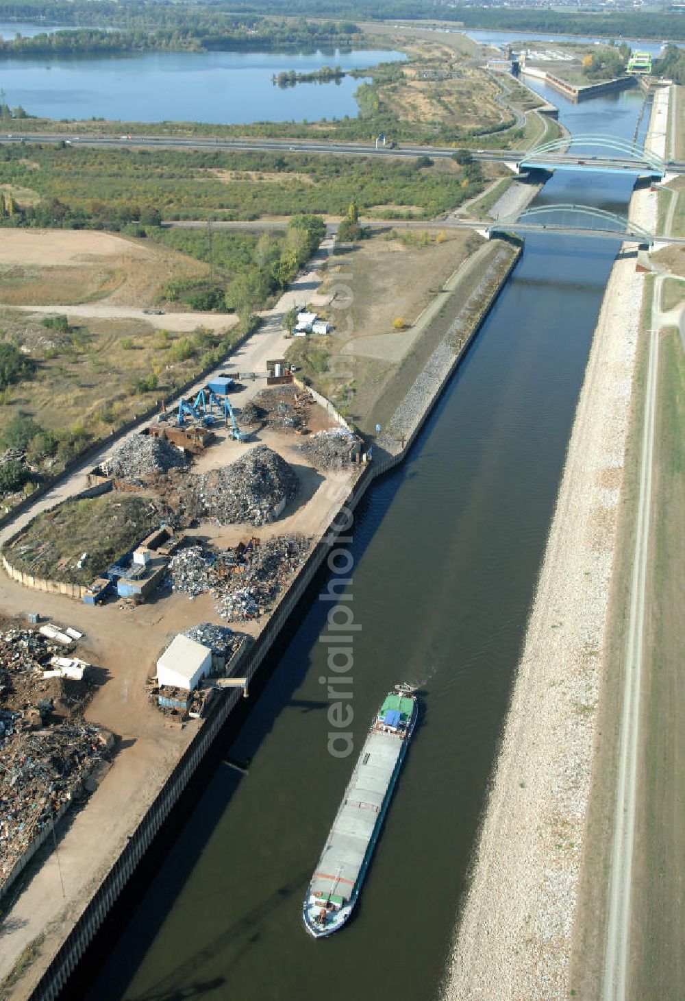 Aerial photograph MAGDEBURG - Blick auf die Industriegebiete am Ufer des Elbe-Abstiegskanal, der den Magdeburger Binnen- Hafen mit der Schleuse Rothensee und dem Mittellandkanal verbindet: Dieser wird auf breiter Front derzeit ausgebaut. Die Bauvorhaben unterstützen die Bestrebungen der Magdeburger Hafengesellschaft, den größten Binnenhafen Mitteldeutschlands zu einer Drehscheibe des internationalen Schiffstransports zu machen. Kontakt WSV: Wasserstraßen-Neubauamt Magdeburg, 39106 Magdeburg, Tel. +49(0)391 535-0, email: wna-magdeburg@wsv.bund.de