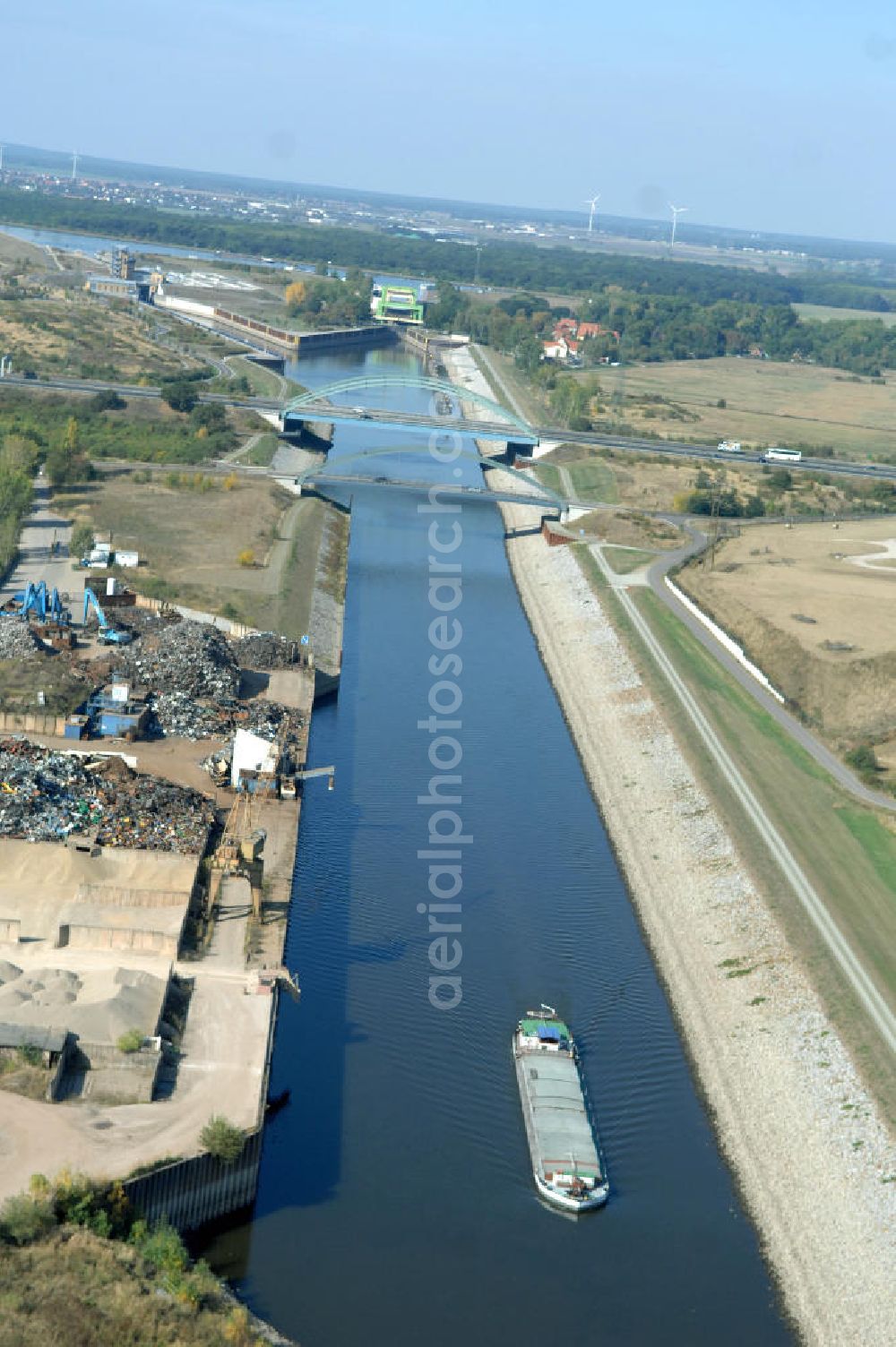 Aerial photograph MAGDEBURG - Blick auf die Industriegebiete am Ufer des Elbe-Abstiegskanal, der den Magdeburger Binnen- Hafen mit der Schleuse Rothensee und dem Mittellandkanal verbindet: Dieser wird auf breiter Front derzeit ausgebaut. Die Bauvorhaben unterstützen die Bestrebungen der Magdeburger Hafengesellschaft, den größten Binnenhafen Mitteldeutschlands zu einer Drehscheibe des internationalen Schiffstransports zu machen. Kontakt WSV: Wasserstraßen-Neubauamt Magdeburg, 39106 Magdeburg, Tel. +49(0)391 535-0, email: wna-magdeburg@wsv.bund.de