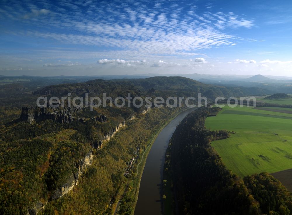 Bad Schandau from above - The river Elbe and the Saxon Switzerland near Postelwitz in the city of Bad Schandau in the state of Saxony. View of the northern Elb shores. The houses belong to the summer resort of Postelwitz. The river runs from West to East here and is characterised by the deep valley. The rocks visible are sandstone and part of the Elbe sandstone mountains