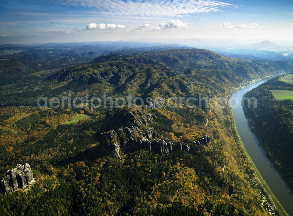 Bad Schandau from above - The river Elbe and the Saxon Switzerland near Postelwitz in the city of Bad Schandau in the state of Saxony. View of the northern Elb shores. The houses belong to the summer resort of Postelwitz. The river runs from West to East here and is characterised by the deep valley. The rocks visible are sandstone and part of the Elbe sandstone mountains