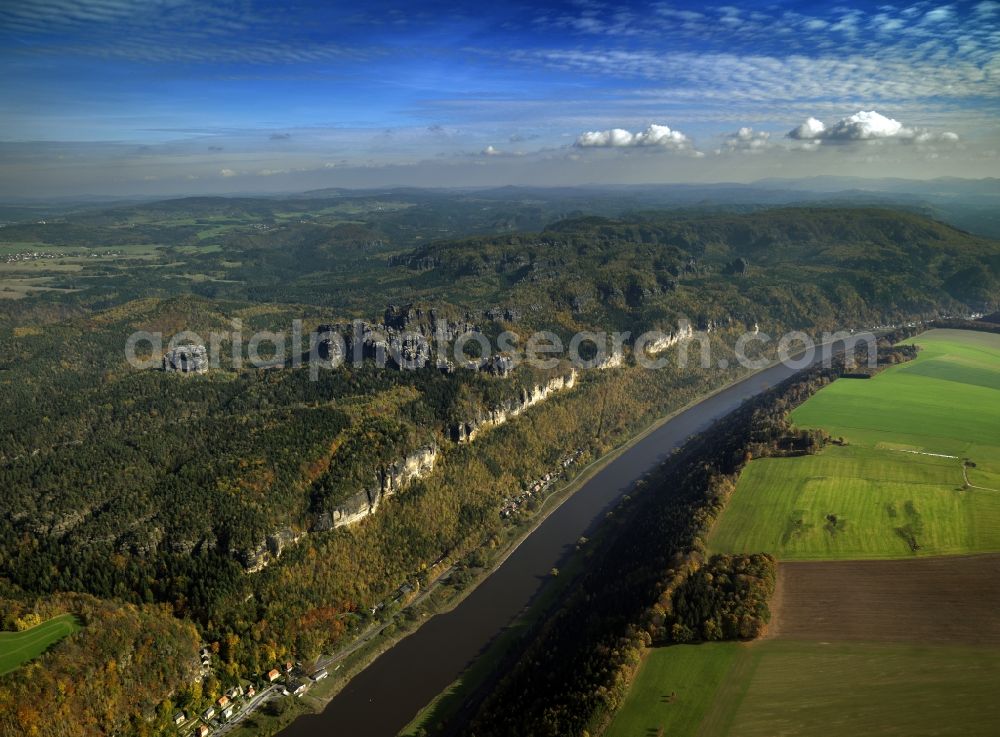 Bad Schandau from the bird's eye view: The river Elbe and the Saxon Switzerland near Postelwitz in the city of Bad Schandau in the state of Saxony. View of the northern Elb shores. The houses belong to the summer resort of Postelwitz. The river runs from West to East here and is characterised by the deep valley. The rocks visible are sandstone and part of the Elbe sandstone mountains