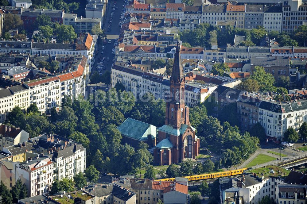 Aerial image Berlin - Blick auf die Emmauskirche am Lausitzer Platz in Berlin- Kreuzberg. Die Planung und Leitung der Kirche wurde August Orth übertragen. Bis zu der Zerstörung des Kirchenschiffs 1945, war die im romanischen Stil gehaltene Emmauskirche mit dem 74 Meter hohem Turm, die Kirche mit den meisten Sitzplätzen in Berlin (ca. 2000). Zwischen 1957 und 1959 wurde ein wesentlich kleineres Kirchenschiff angebaut. View at the Emmaus Church on Lausitzer Platz in Berlin- Kreuzberg. The planning and management of the church August Orth has been transferred. Up to the destruction of the nave in 1945, the Romanesque-style Emmaus Church with the 74-meter high tower was the chruch with the most seats in Berlin. Between 1957 and 1959, a much smaller nave was added.