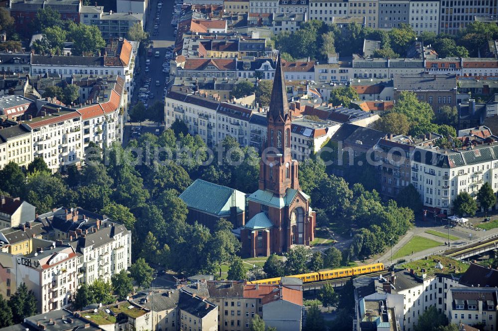 Aerial photograph Berlin - Blick auf die Emmauskirche am Lausitzer Platz in Berlin- Kreuzberg. Die Planung und Leitung der Kirche wurde August Orth übertragen. Bis zu der Zerstörung des Kirchenschiffs 1945, war die im romanischen Stil gehaltene Emmauskirche mit dem 74 Meter hohem Turm, die Kirche mit den meisten Sitzplätzen in Berlin (ca. 2000). Zwischen 1957 und 1959 wurde ein wesentlich kleineres Kirchenschiff angebaut. View at the Emmaus Church on Lausitzer Platz in Berlin- Kreuzberg. The planning and management of the church August Orth has been transferred. Up to the destruction of the nave in 1945, the Romanesque-style Emmaus Church with the 74-meter high tower was the chruch with the most seats in Berlin. Between 1957 and 1959, a much smaller nave was added.