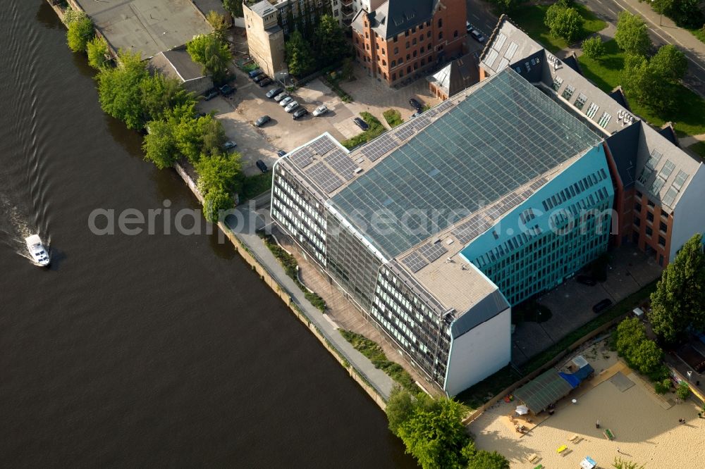 Berlin from above - The Energieforum Berlin at the street Stralauer Platz in Berlin-Friedrichshain. The forum has a residential building and a glassy new building