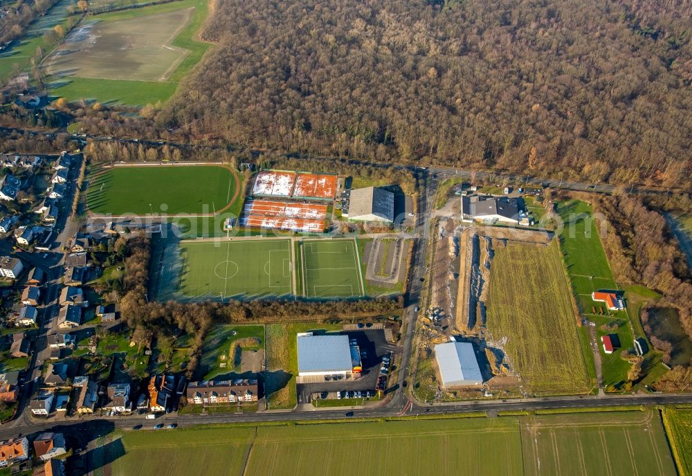 Hamm from above - Ensemble of sports grounds for soccer and tennis at the edge of a forest area in Hamm in the state North Rhine-Westphalia