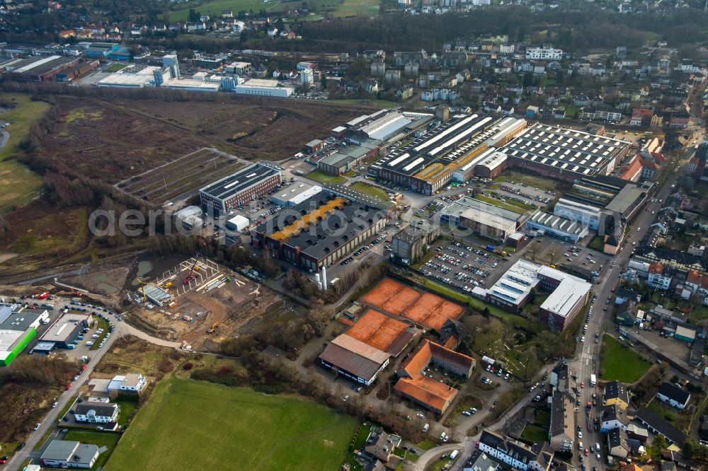 Witten from the bird's eye view: Ensemble of sports grounds of Sport-UNION Annen eV adjacent to the industrial and commercial area on Stockumer Strasse in Witten in the state of North Rhine-Westphalia. The sports grounds are located adjacent to a construction site on Salinger Feld and the hardening plant of Haerterei VTN GmbH