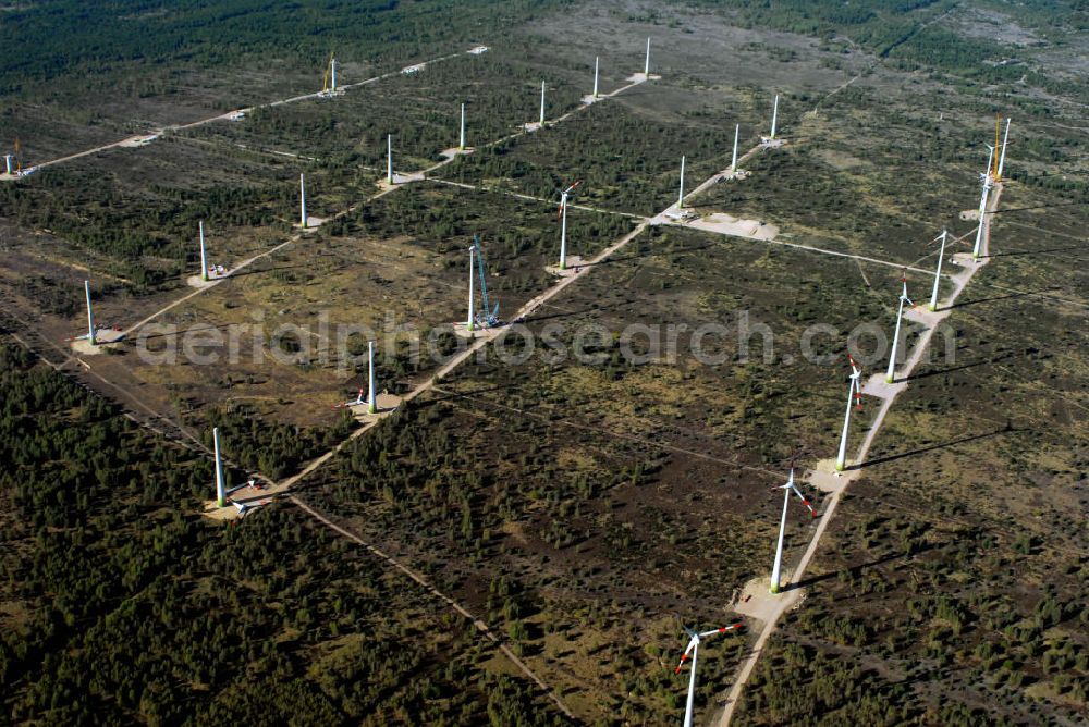 Jüterborg from the bird's eye view: Blick auf die Entstehung eines Windparks im Teltow - Fläming in Brandenburg. In der Nähe der Stadt Jüterbog wird ein neuer Windkraftpark errichtet. Die Windräder haben den Zweck Windernergie in Strom umzuwandeln, der in das Stromnetz eingespeist werden kann. Es handelt sich dabei um 25 Windräder der Firma REpower Systems AG ( Standort Hamburg ). Kontakt: REpower Systems AG, Überseering 10 / Oval Office, 22297 Hamburg, Tel. +49(0)40 5555090 0, Fax +49(0)40 5555090 3999, Email: info@repower.de