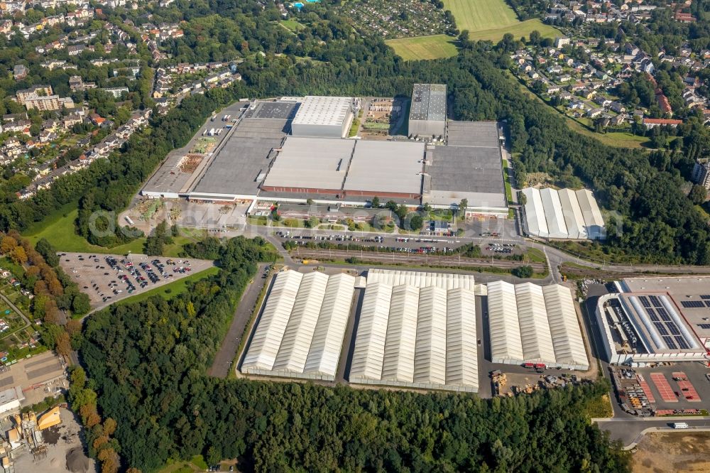 Bochum from the bird's eye view: Development area of the former industrial and commercial area of the Opel-Flaeche next to the building of the branch of Baumarkt direkt GmbH & Co KG along the main street in Bochum in the state of North Rhine-Westphalia, Germany