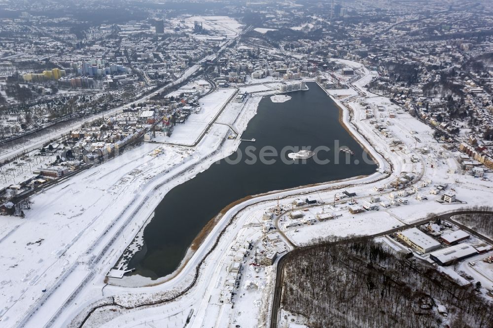 Aerial photograph Dortmund - Winter - Aerial view of snow-covered area of ??residential development at Phoenix Lake in Dortmund in North Rhine-Westphalia NRW. The Phoenix Lake is an artificial lake with buildable riparian zones on the former steelworks site Phoenix-East. Foto: Hans Blossey