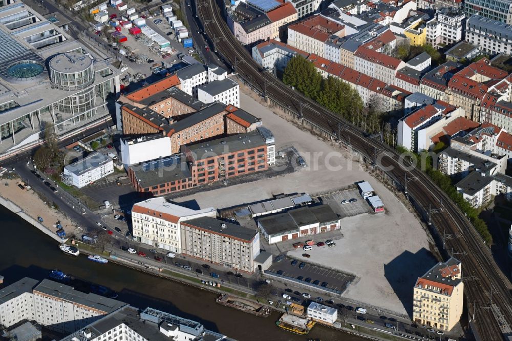 Aerial image Berlin - Developing field of residential and commercial space on Schiffbauerdamm on Spree river in the district Mitte in Berlin, Germany