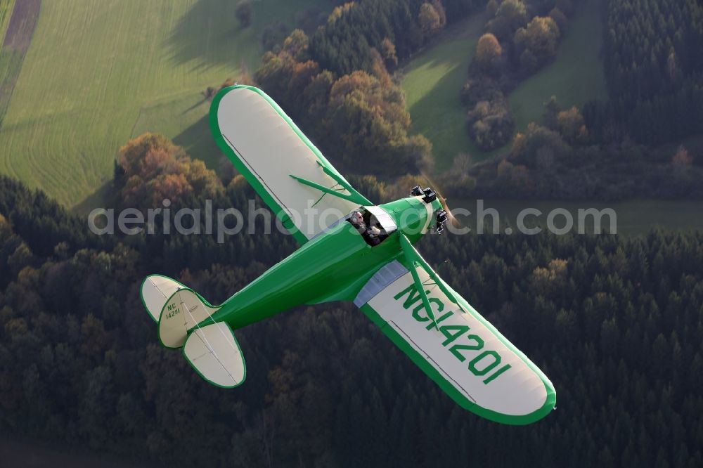 Mengen from above - 1934er aircraft Kinner Sportster B with the identifier NC14201ueber the autumnal leaf forest landscape at levels in the state of Baden-Wuerttemberg