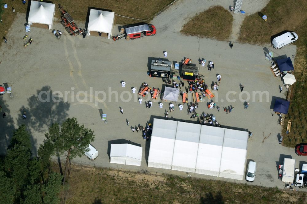 Aerial image Sallgast - Opening party of the forest- windpark Goellnitz-Lieskau-Rehain in Sallgast in the state of Brandenburg. Developed by UKA the largest forest windpark of Germany opens with tents, drinks and stands on the foot of a turbine in a forest