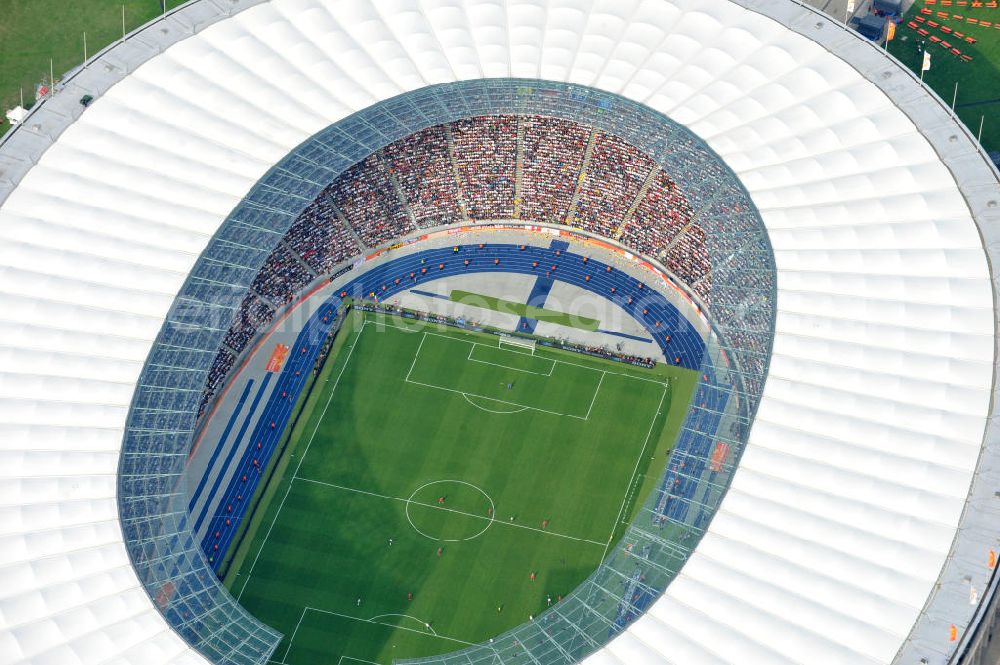 Aerial photograph Berlin - Blick auf das Eröffnungsspiel der Fußball-Weltmeisterschaft der Frauen 2011 im Berliner Olympiastadion. Die deutsche Nationalmannschaft der Frauen trifft auf die Mannschaft Kanadas, Die 6. Fußball-Weltmeisterschaft der Frauen (offiziell: FIFA Women’s World Cup Germany 2011 / „ FIFA Frauen-Weltmeisterschaft Deutschland 2011 “) wird vom 26. Juni bis 17. Juli 2011 im Land des Titelverteidigers Deutschland ausgetragen. Opening match of the FIFA Women's World Cup 2011 in Berlin's Olympic Stadium.