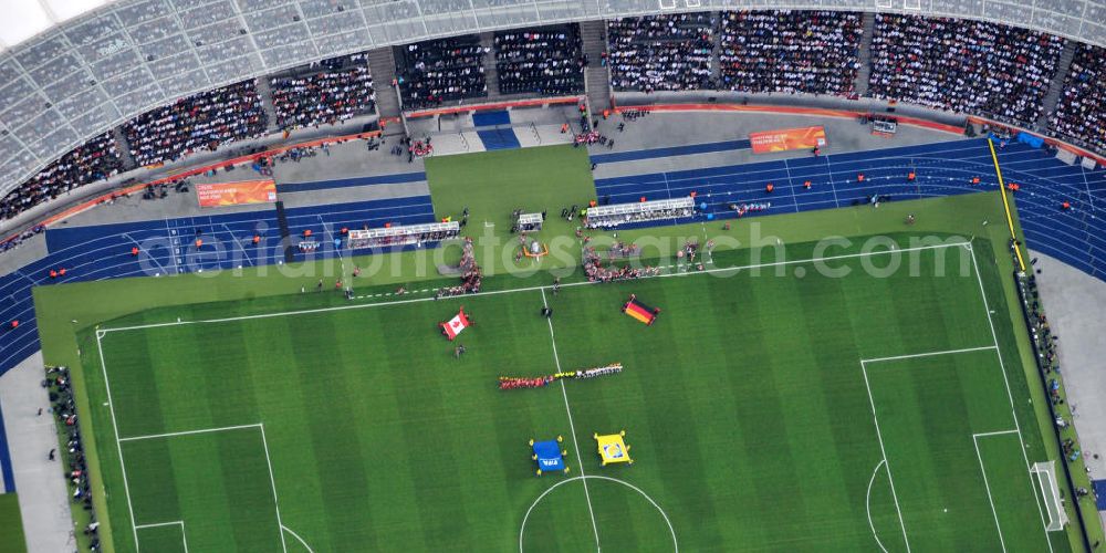 Berlin from the bird's eye view: Blick auf das Eröffnungsspiel der Fußball-Weltmeisterschaft der Frauen 2011 im Berliner Olympiastadion. Die deutsche Nationalmannschaft der Frauen trifft auf die Mannschaft Kanadas, Die 6. Fußball-Weltmeisterschaft der Frauen (offiziell: FIFA Women’s World Cup Germany 2011 / „ FIFA Frauen-Weltmeisterschaft Deutschland 2011 “) wird vom 26. Juni bis 17. Juli 2011 im Land des Titelverteidigers Deutschland ausgetragen. Opening match of the FIFA Women's World Cup 2011 in Berlin's Olympic Stadium.