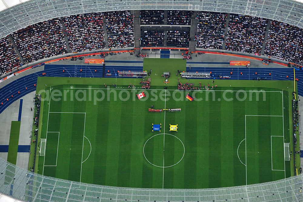 Aerial photograph Berlin - Blick auf das Eröffnungsspiel der Fußball-Weltmeisterschaft der Frauen 2011 im Berliner Olympiastadion. Die deutsche Nationalmannschaft der Frauen trifft auf die Mannschaft Kanadas, Die 6. Fußball-Weltmeisterschaft der Frauen (offiziell: FIFA Women’s World Cup Germany 2011 / „ FIFA Frauen-Weltmeisterschaft Deutschland 2011 “) wird vom 26. Juni bis 17. Juli 2011 im Land des Titelverteidigers Deutschland ausgetragen. Opening match of the FIFA Women's World Cup 2011 in Berlin's Olympic Stadium.