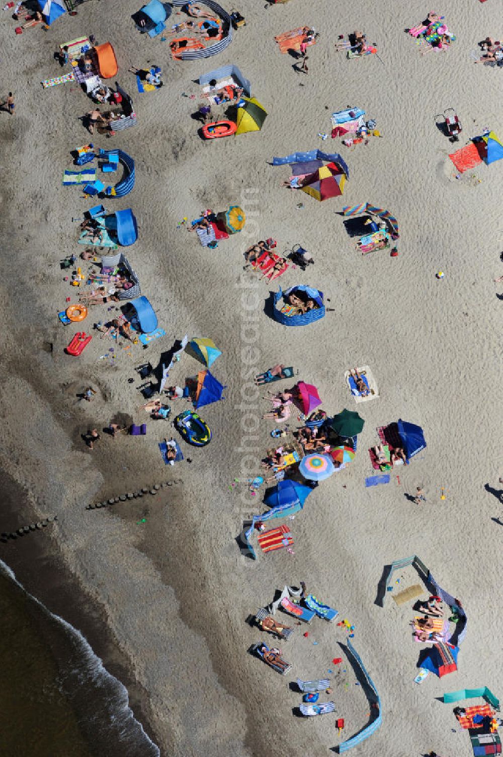 Ostseebad Graal Müritz from the bird's eye view: Blick Strandburgen mit Erholungs- und Badebetrieb bei sonnigem Wetter am Strand des Ostseeheilbades Graal-Müritz. Der Ostseestrand von Graal-Müritz zieht jede Saison tausende sonnenhungrige Urlauber und Gäste aus allen Bundesländern in das beliebte Erholungsgebiet und den Luftkurort an. ACHTUNG! Verwendung in Zoomausschnitten nicht gestattet! Holiday and Recreation and bathing on the beach in sunny weather of the Graal-Müritz. WARNING! Using a zoom is not allowed!