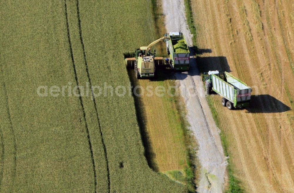 Aerial image Kranichfeld - Combines during the harvest of an agricultural fiel in Thuringia