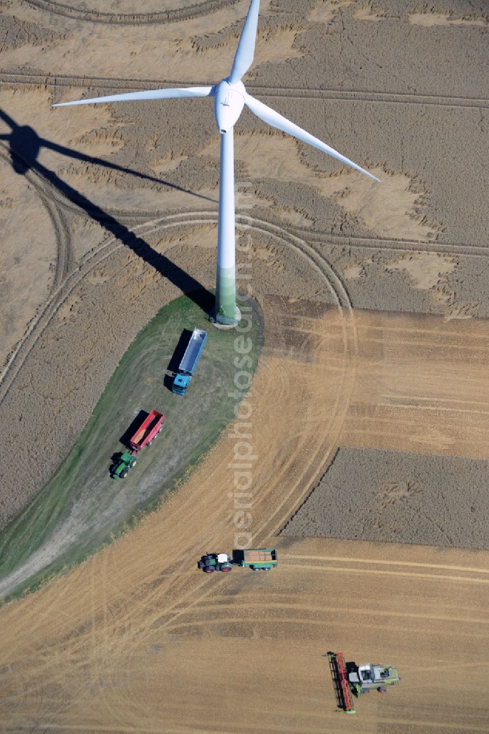 Aerial image Dalkendorf - Harvest use of heavy agricultural machinery - combine harvesters and harvesting vehicles on agricultural fields in Dalkendorf in the state Mecklenburg - Western Pomerania