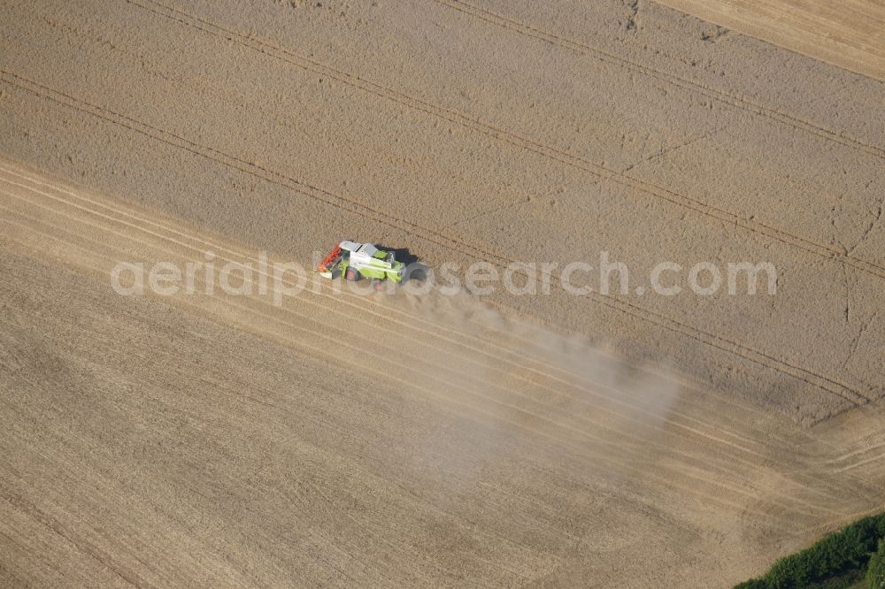 Friedland from the bird's eye view: Harvest use of heavy agricultural machinery - combine harvesters and harvesting vehicles on agricultural fields in Friedland in the state Lower Saxony