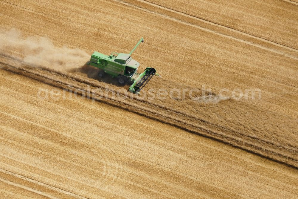 Aerial photograph Rosdorf - Harvest use of heavy agricultural machinery - combine harvesters and harvesting vehicles on agricultural fields in Rosdorf in the state Lower Saxony