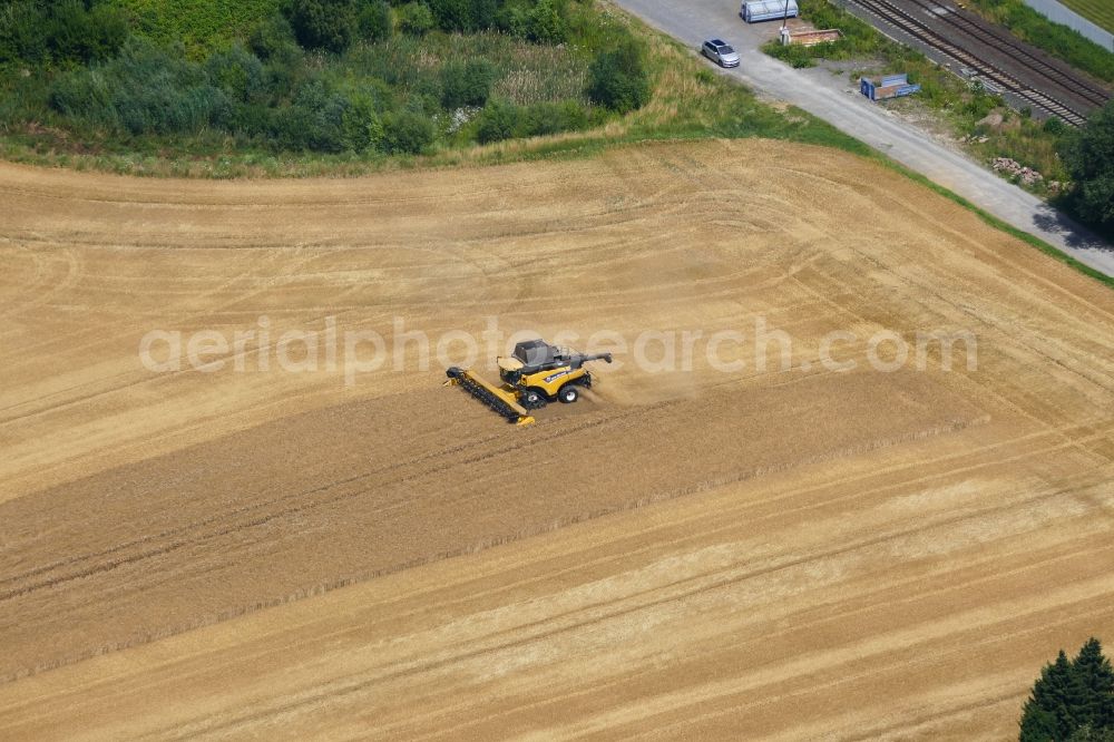 Aerial photograph Rosdorf - Harvest use of heavy agricultural machinery - combine harvesters and harvesting vehicles on agricultural fields in Rosdorf in the state Lower Saxony