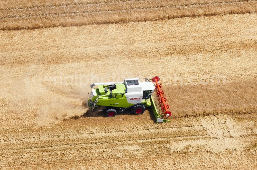 Aerial image Rosdorf - Harvest use of heavy agricultural machinery - combine harvesters and harvesting vehicles on agricultural fields in Rosdorf in the state Lower Saxony, Germany