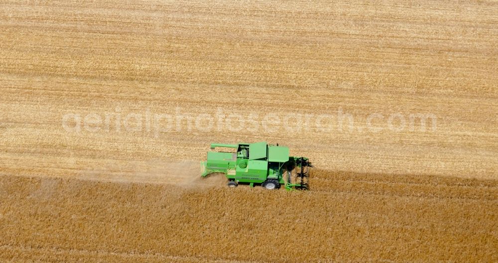 Aerial photograph Rosdorf - Harvest use of heavy agricultural machinery - combine harvesters and harvesting vehicles on agricultural fields in Rosdorf in the state Lower Saxony, Germany