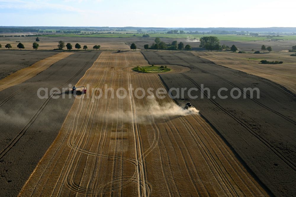 Schapow from above - Harvest use of heavy agricultural machinery - combine harvesters and harvesting vehicles on agricultural fields in Schapow Uckermark in the state Brandenburg, Germany
