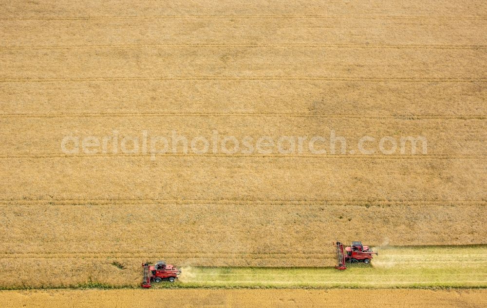 Aerial photograph Vipperow - Harvest use of heavy agricultural machinery - combine harvesters and harvesting vehicles on agricultural fields in Vipperow in the state Mecklenburg - Western Pomerania