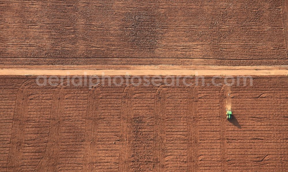 Aerial photograph Manacor - Harvest with traktor engine on agricultural fields in Manacor in Mallorca in Balearic Islands, Spain