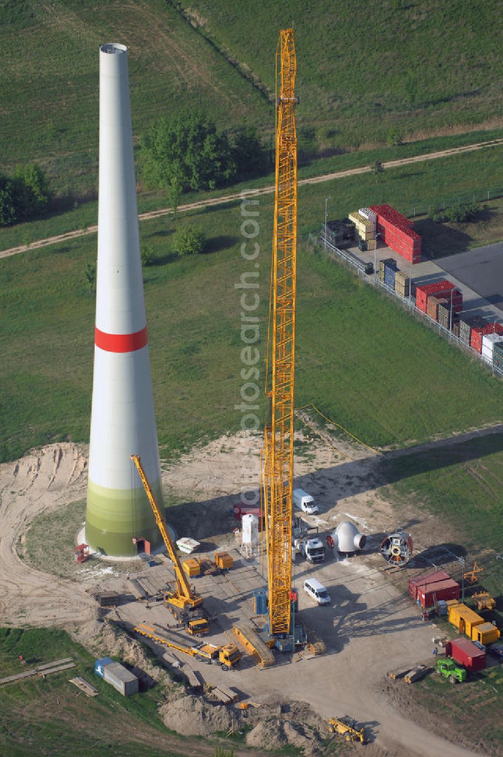 Aerial image Berlin - Blick auf das Erste Windrad Berlins im Gewerbegebiet Pankow Berlin. Nach Klagen des Naturschutzbundes NABU wurde der Bau des ersten Windkraftrads im April 2008 bewilligt. Es soll eine Höhe von 180 Metern betragen und ist mit einer Leistung von zwei Megawatt in der Lage ca. 1000 Vier - Personen - Haushalte für ein Jahr zu versorgen. Aufgrund eines neuen Erneuerbare - Energien - Gesetz (EEG) wird die Anlage erst mit in Kraft treten des Gesetzen im Januar 2009 in Betrieb genommen. Das Rad ist eine von Enercon gebaute E82. Kontakt Enercon: ENERCON GmbH, Dreekamp 5, 26605 Aurich, Tel. +49(0)4941 927 0, Fax +49(0)4941 927 109, Email: info@enercon.de