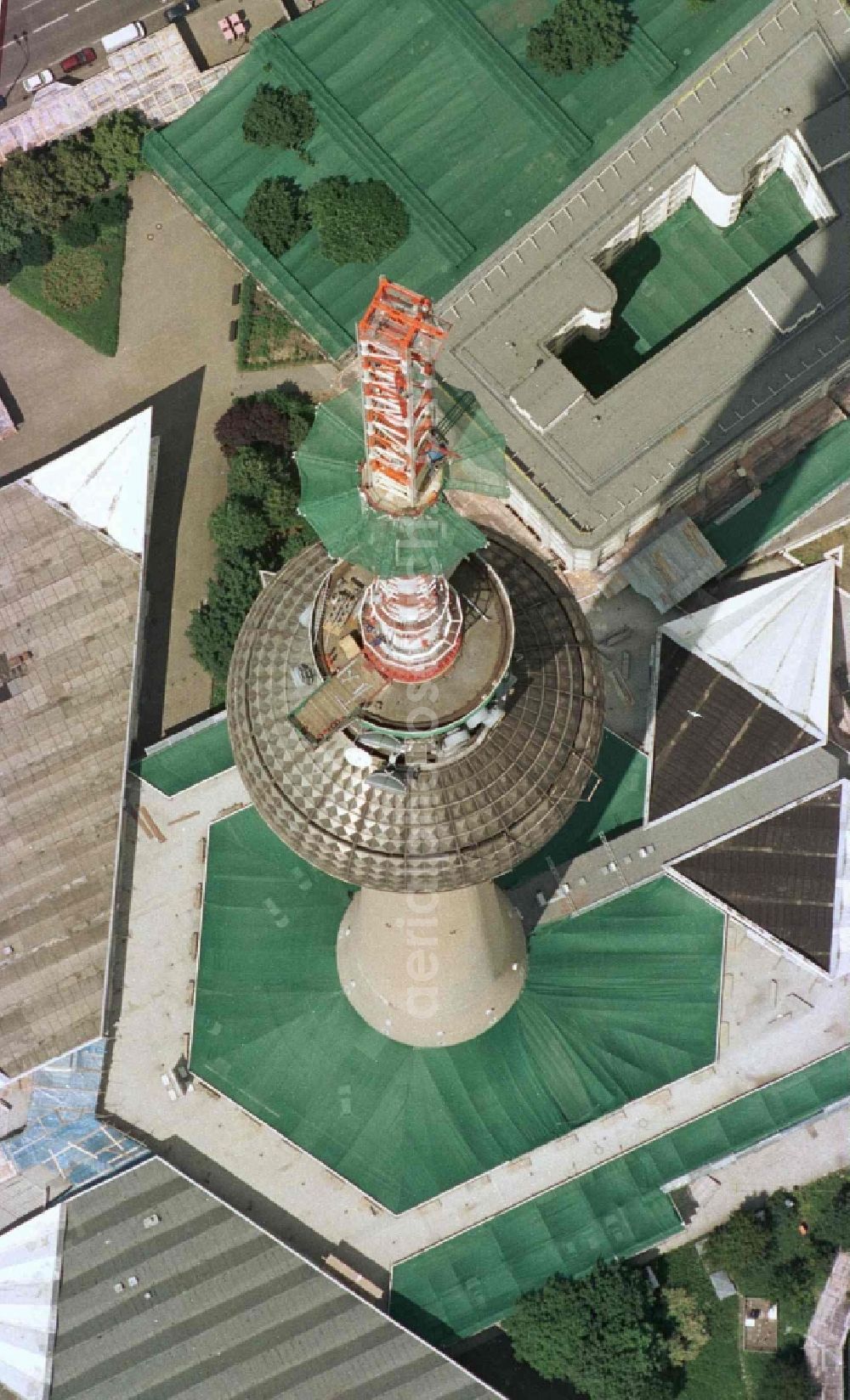 Aerial photograph Berlin - Extension construction site to raise the steel mast antenna support above the shiny silver sphere of the telecommunications tower building and television tower in Mitte in Berlin, Germany