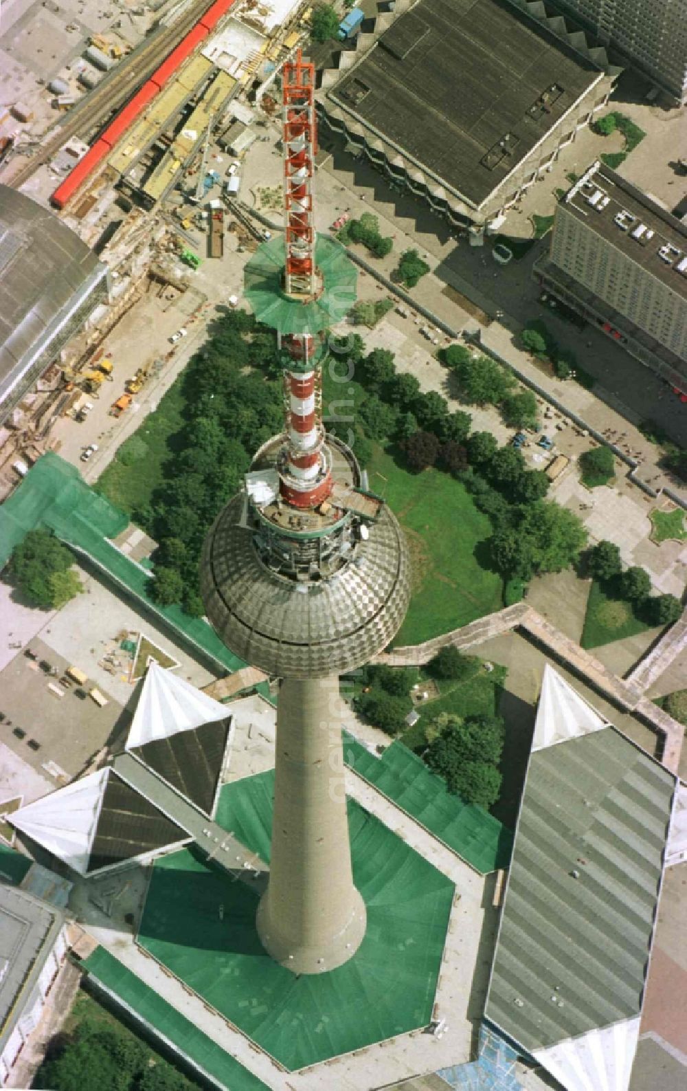 Aerial photograph Berlin - Extension construction site to raise the steel mast antenna support above the shiny silver sphere of the telecommunications tower building and television tower in Mitte in Berlin, Germany