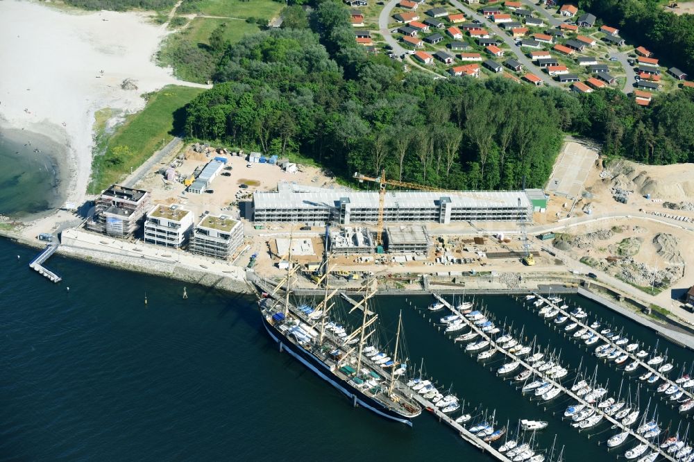 Aerial image Travemünde - The Priwall harbour in the Travemuende part of Luebeck in the state of Schleswig-Holstein. The harbour is located at the river Trave on the mouth to the Baltic Sea. The harbour is on the Eastern riverbank on the peninsula of Priwall. It is primarily a yacht port, also used for sailing ships and ferries