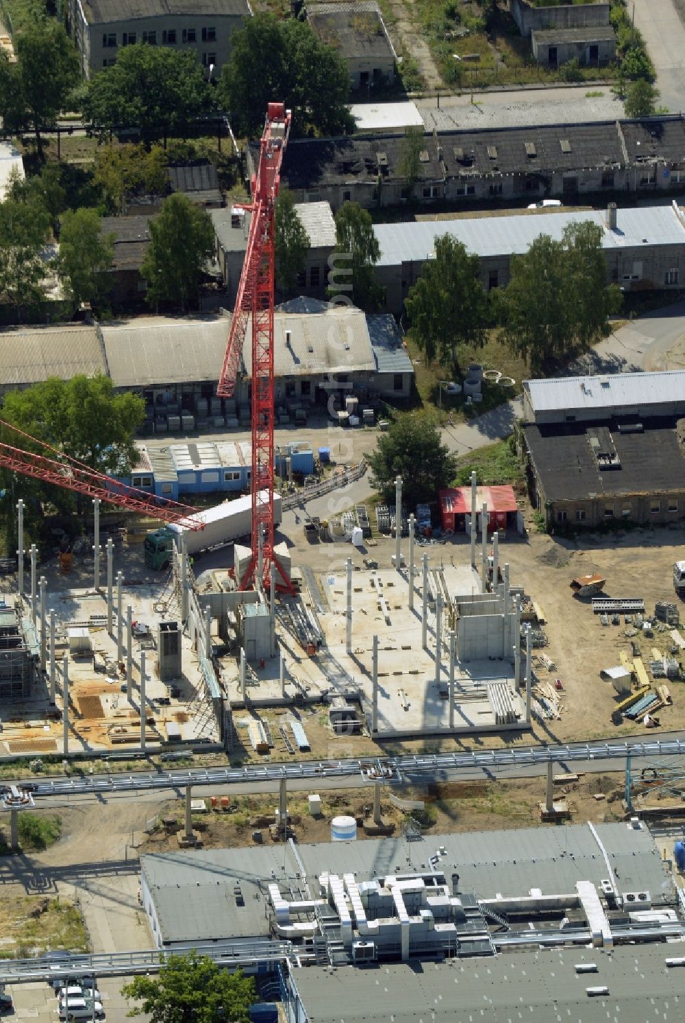 Berlin from above - Expansion construction site on the grounds of the Berlin Chemie AG in Adlershof. The Berlin-based pharmaceutical company is part of the pharmaceutical company Menarini