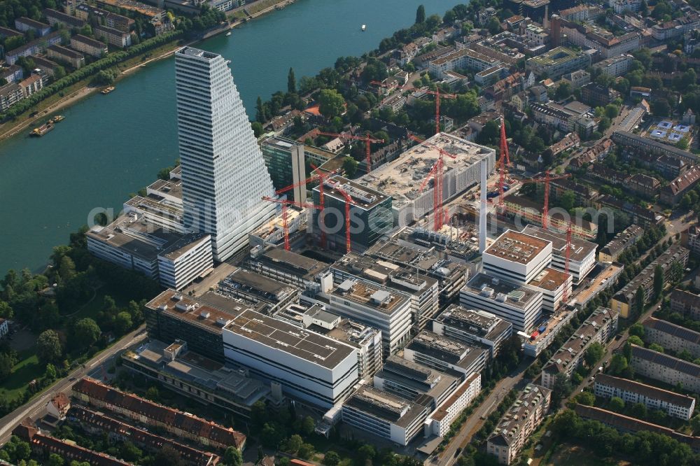 Basel from the bird's eye view: Extension construction sites on the premises and premises of the pharmaceutical company Roche with the cityscape-defining high-rise in Basel in Switzerland