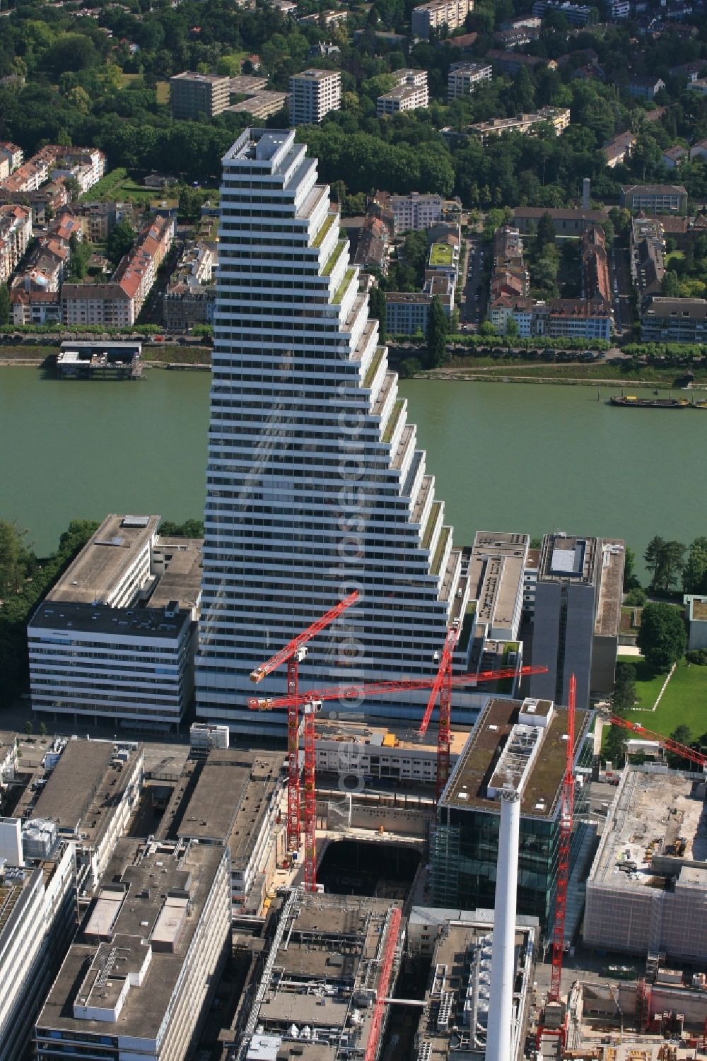 Basel from above - Extension construction sites on the premises and premises of the pharmaceutical company Roche with the cityscape-defining high-rise in Basel in Switzerland