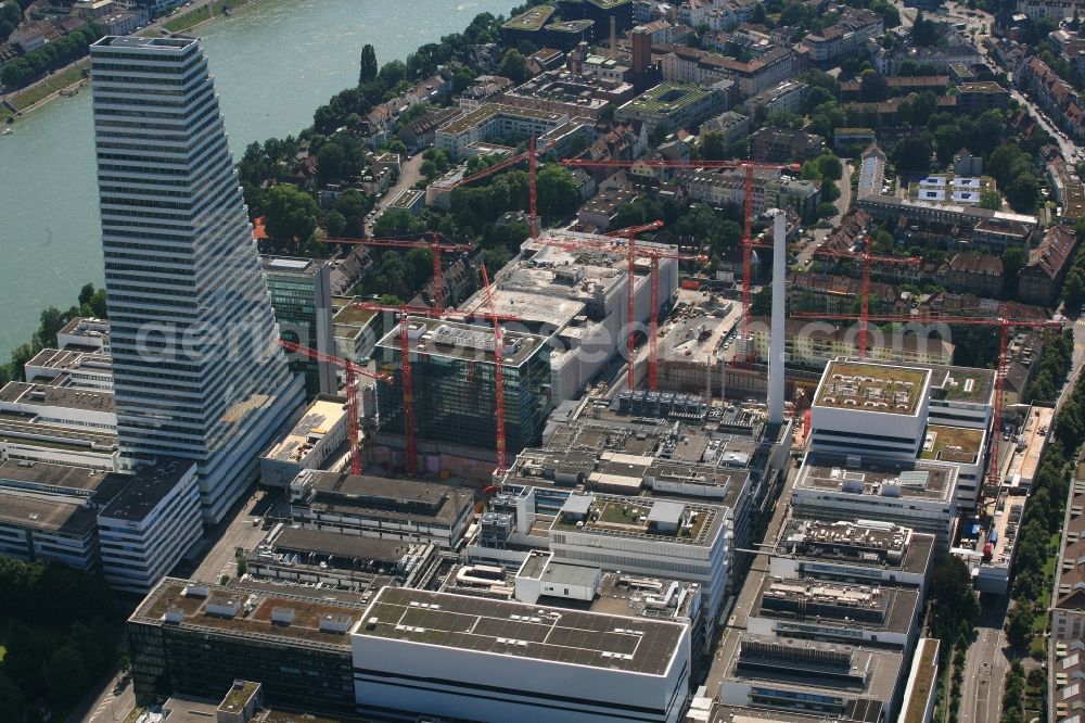 Basel from the bird's eye view: Extension construction sites on the premises and premises of the pharmaceutical company Roche with the cityscape-defining high-rise in Basel in Switzerland