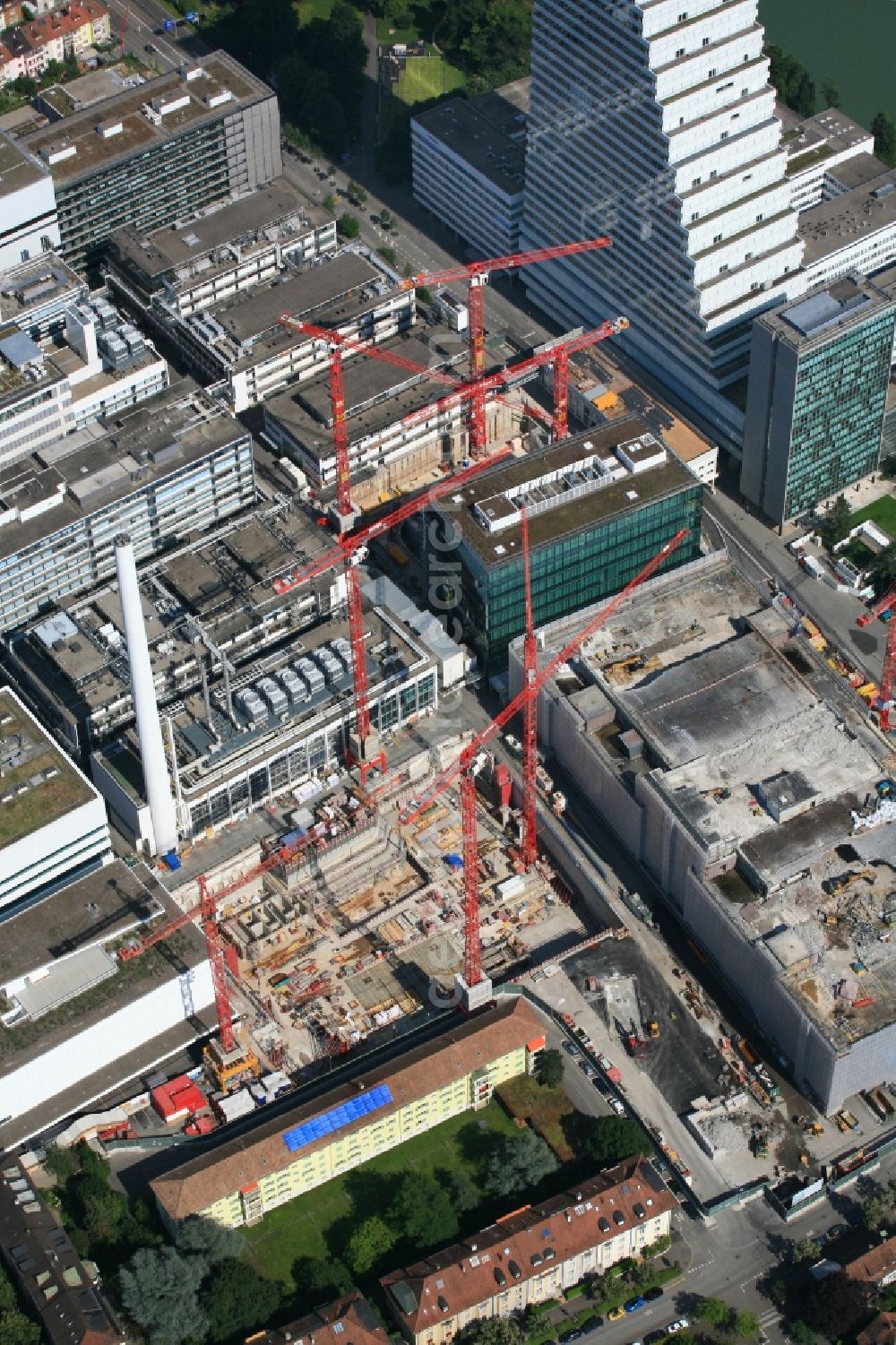 Aerial photograph Basel - Extension construction sites on the premises and premises of the pharmaceutical company Roche with the cityscape-defining high-rise in Basel in Switzerland