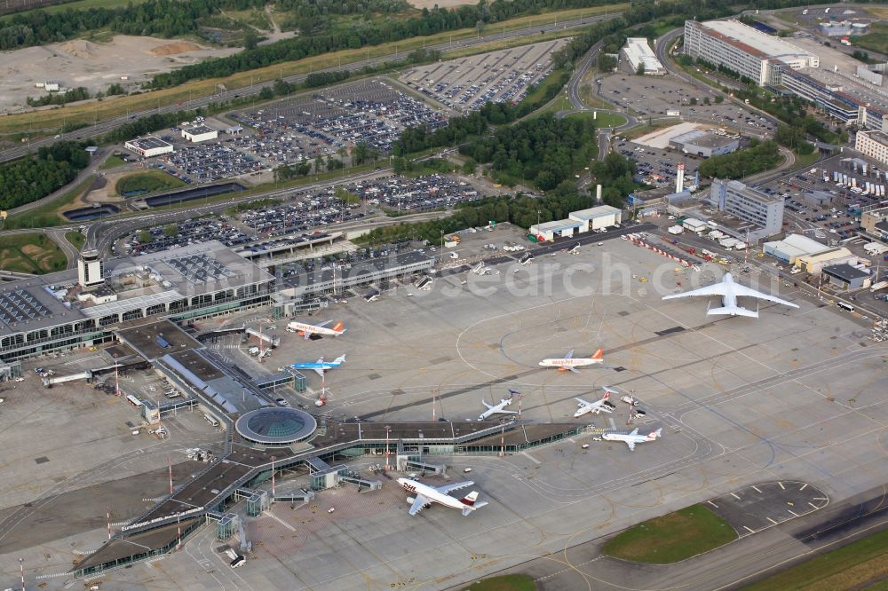 Aerial photograph Saint-Louis - The russian Antonov AN-225, the largest cargo aircraft in the world, on the tri-national Euroairport Basel-Mulhouse-Freiburg in Saint-Louis in France. The six-jet cargo aircraft has a wingspan of 88.4 meters and leaves the other airliners appear comparatively tiny on the apron. There is only one flying AN-225 in the world