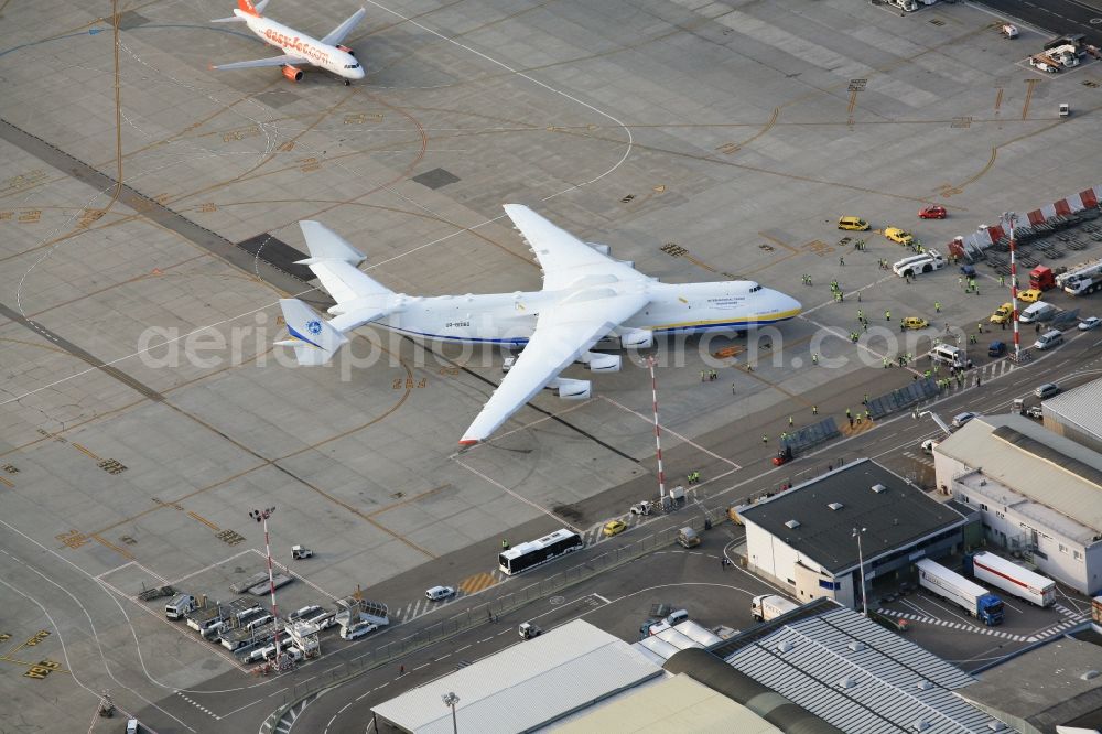 Aerial image Saint-Louis - The russian Antonov AN-225, the largest cargo aircraft in the world, on the tri-national Euroairport Basel-Mulhouse-Freiburg in Saint-Louis in France. The six-jet cargo aircraft has a wingspan of 88.4 meters and leaves the other airliners appear comparatively tiny on the apron. There is only one flying AN-225 in the world