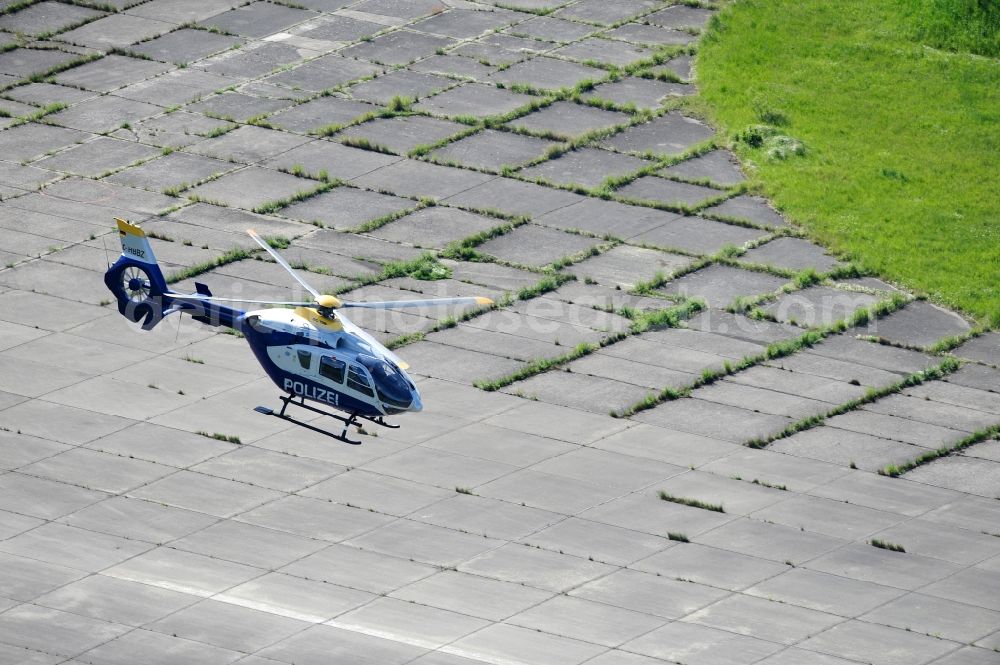 Aerial photograph Werneuchen - View one just above the runway / runway of the airfield Werneuchen floating Eurocopter with the registration D-HBBZ the Federal Police